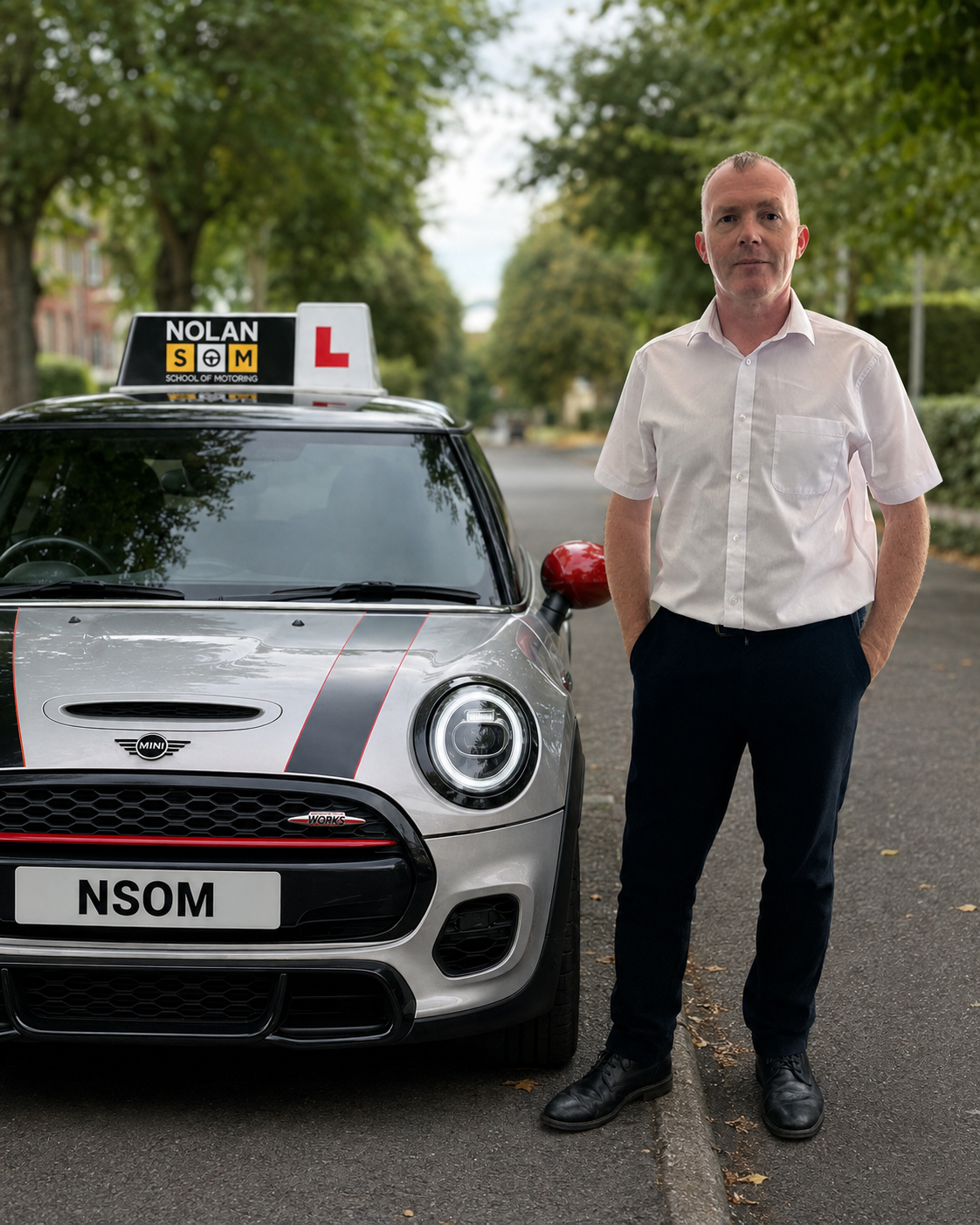 Gary Nolan, driving instructor at Nolan School of Motoring, standing beside his learner MINI