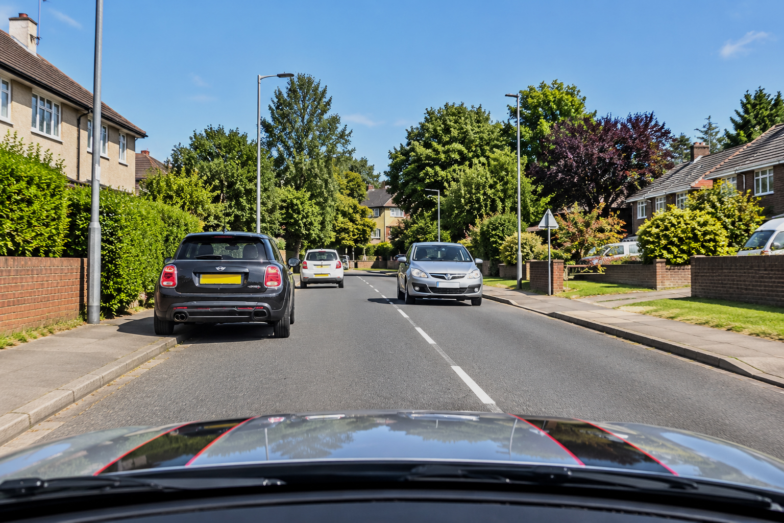Learner driver approaching parked vehicles and oncoming traffic during a meeting and clearance lesson